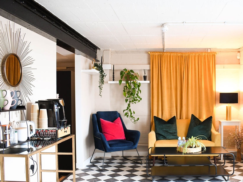 Waiting area with sofa, chair, coffee machine and snacks