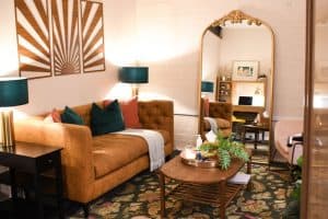 Warm therapy room at The Good Life Therapy Centre in Exeter with a sofa and soft lighting.