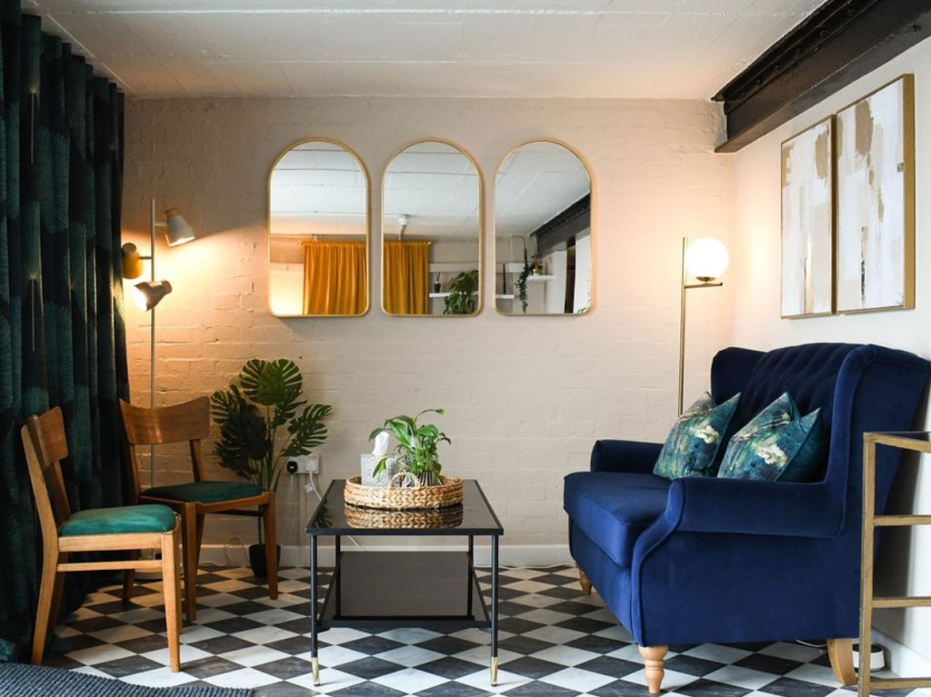 Welcoming waiting room with sofa, chairs, coffee table and refreshments